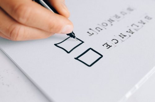A hand drawing checkboxes on a checklist, themed around balance and burnout.